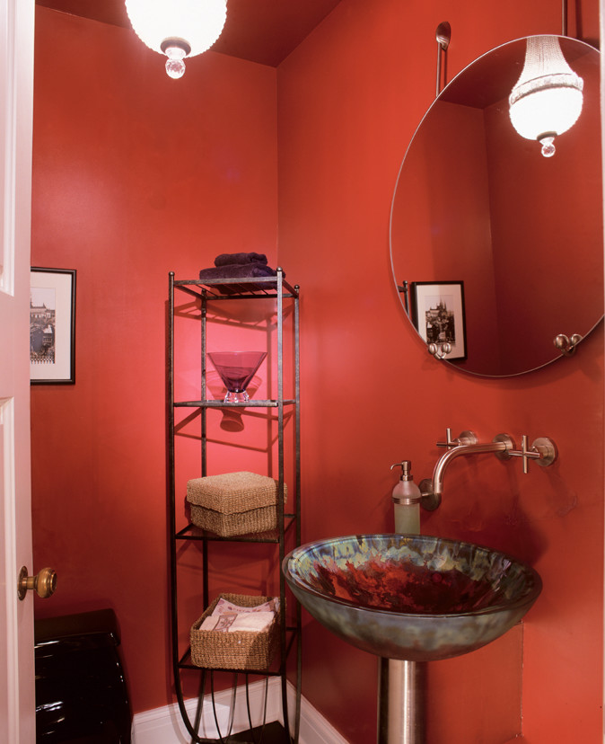Photo of a small modern powder room in Denver with a wall-mount sink, a one-piece toilet, red walls and glass benchtops.