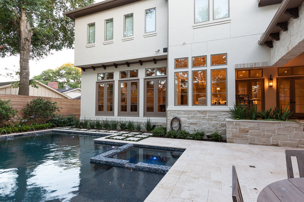 Photo of a transitional backyard l-shaped natural pool in Houston with a hot tub.