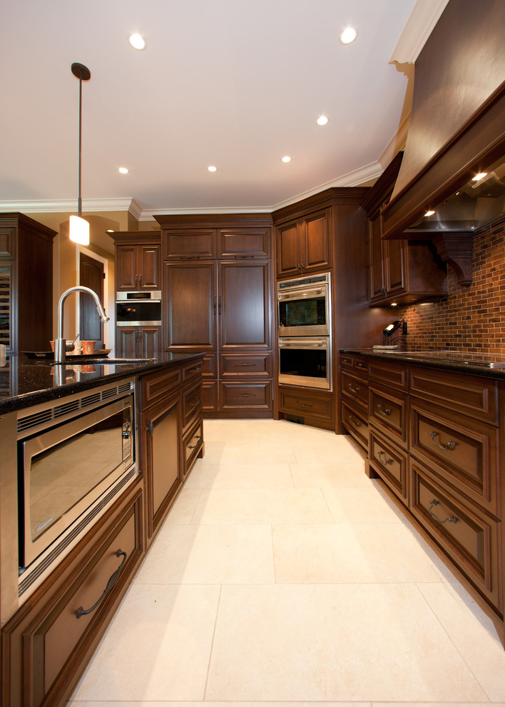 Open concept kitchen - huge rustic u-shaped porcelain tile and beige floor open concept kitchen idea with an undermount sink, raised-panel cabinets, dark wood cabinets, granite countertops, red backsplash, porcelain backsplash, stainless steel appliances and a peninsula
