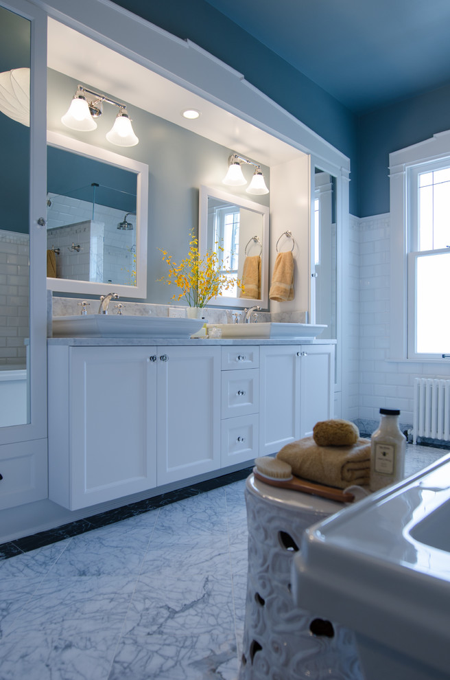 Photo of a mid-sized traditional master bathroom in Seattle with shaker cabinets, white cabinets, a freestanding tub, a corner shower, gray tile, subway tile, blue walls, marble floors and marble benchtops.