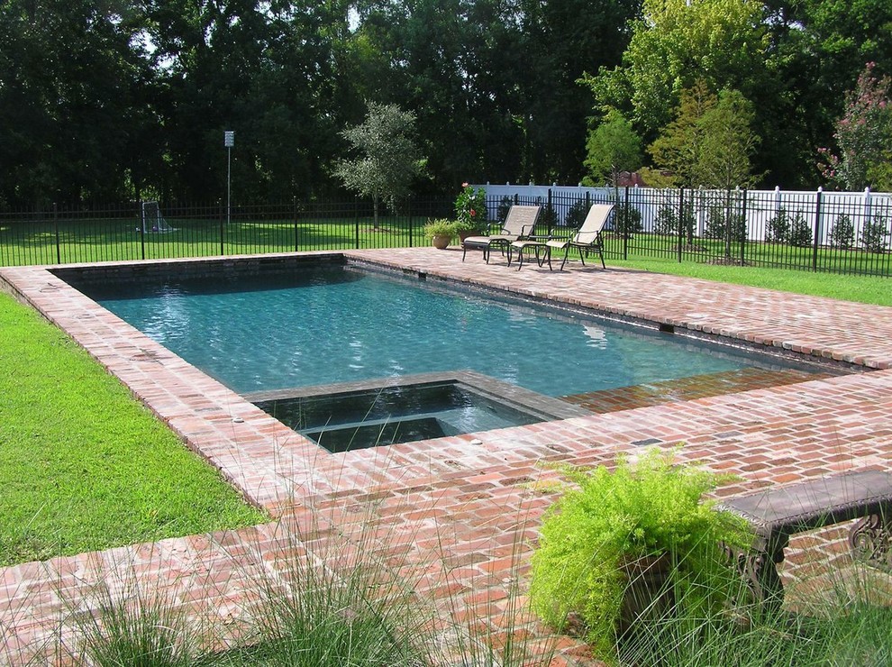 Hot tub - mid-sized transitional backyard brick and rectangular lap hot tub idea in New Orleans