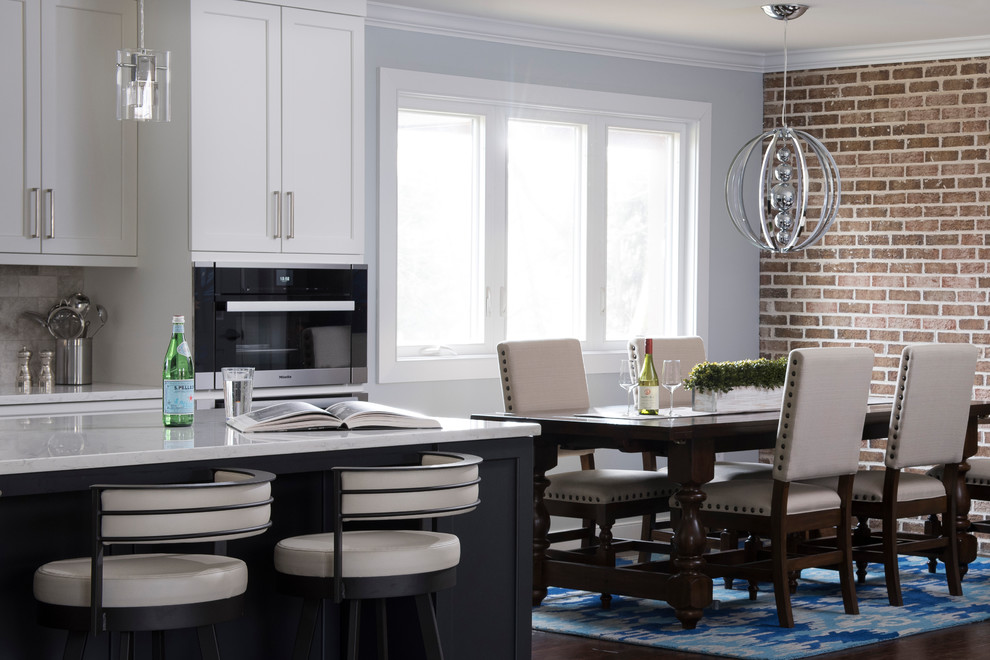 Large transitional dark wood floor and brown floor enclosed dining room photo in Philadelphia with a drop-in sink, white cabinets, quartz countertops, gray backsplash, marble backsplash, stainless steel appliances, an island, multicolored walls and no fireplace