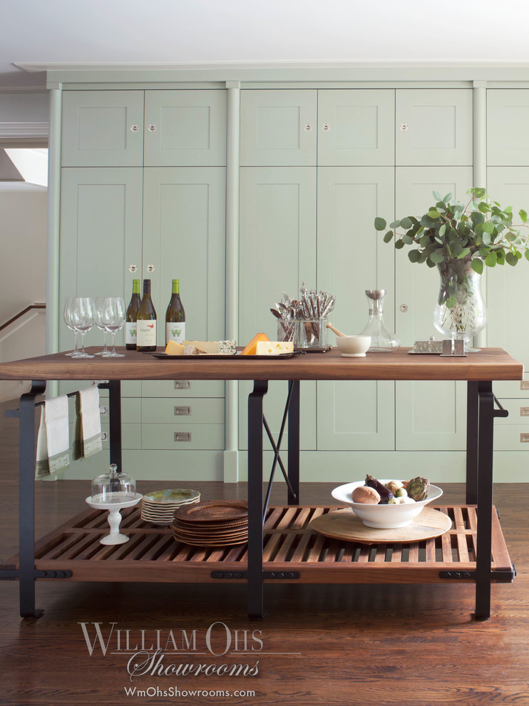 Example of a large transitional u-shaped medium tone wood floor eat-in kitchen design in Denver with a farmhouse sink, flat-panel cabinets, gray cabinets, marble countertops, white backsplash, glass tile backsplash, stainless steel appliances, white walls and an island