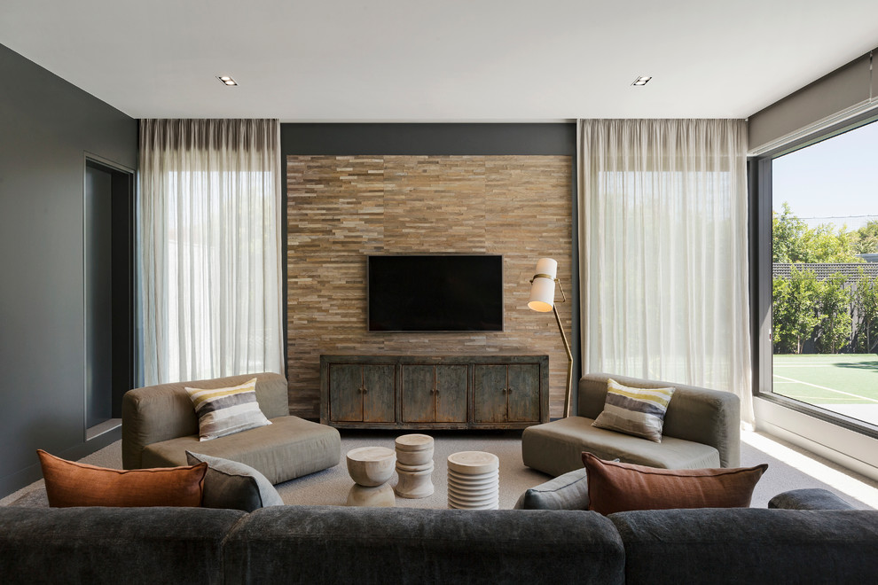 Inspiration for a contemporary living room in Melbourne with black walls, carpet, a wall-mounted tv and beige floor.