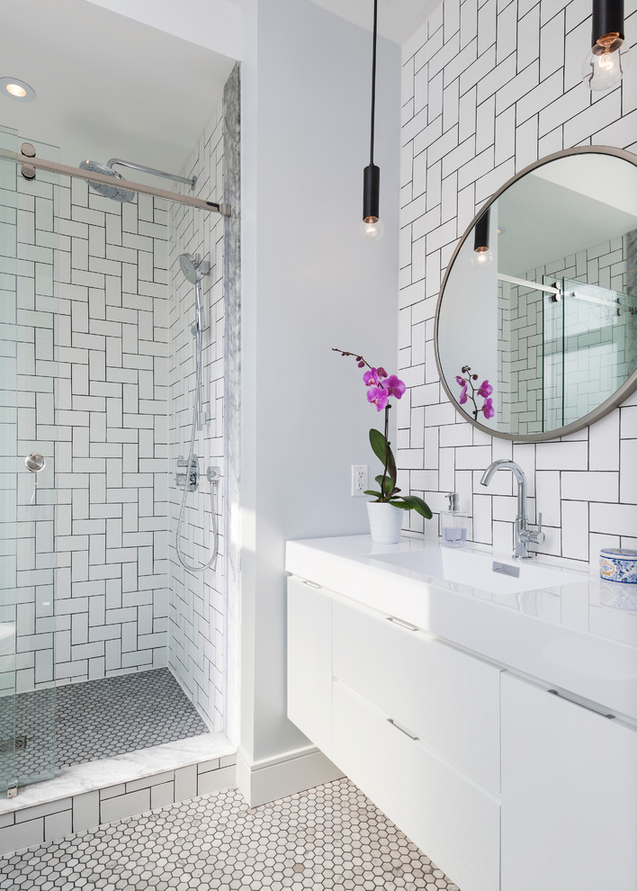 Design ideas for a small contemporary master bathroom in Toronto with flat-panel cabinets, white cabinets, white tile, subway tile, white walls, marble floors, an integrated sink, an alcove shower and a sliding shower screen.