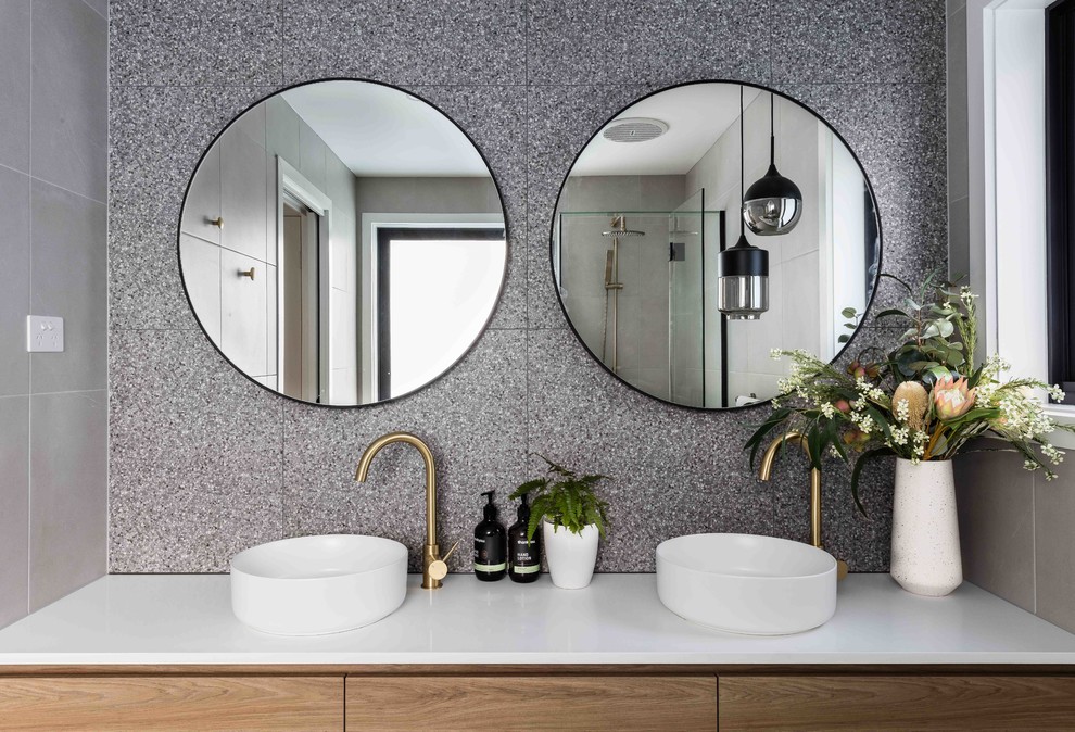 Photo of a mid-sized modern kids bathroom in Melbourne with open cabinets, medium wood cabinets, a corner shower, a two-piece toilet, black and white tile, beige walls, a drop-in sink, engineered quartz benchtops, beige floor, a hinged shower door and yellow benchtops.