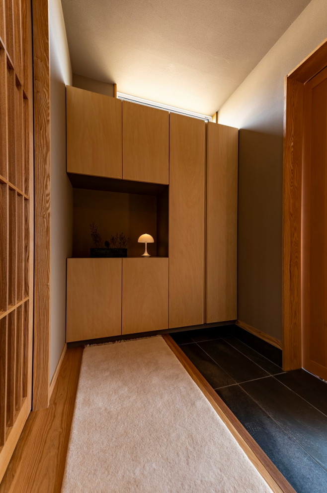 Mid-sized entry hall in Other with metallic walls, ceramic floors, a sliding front door, a medium wood front door and grey floor.