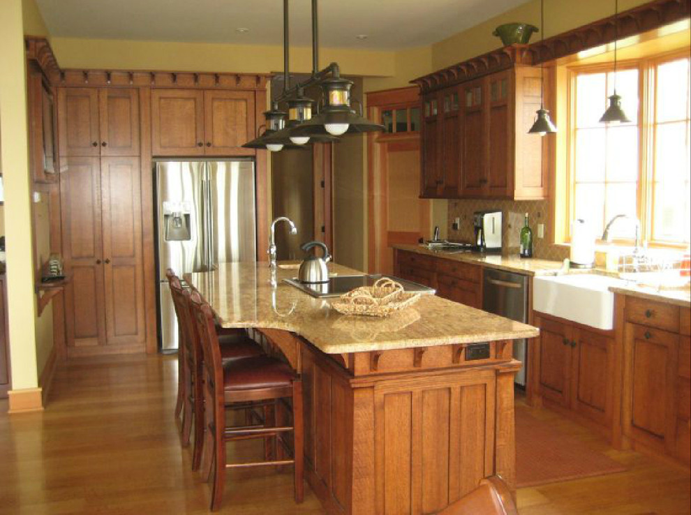 Inspiration for a medium tone wood floor kitchen remodel with medium tone wood cabinets, granite countertops, stainless steel appliances and an island