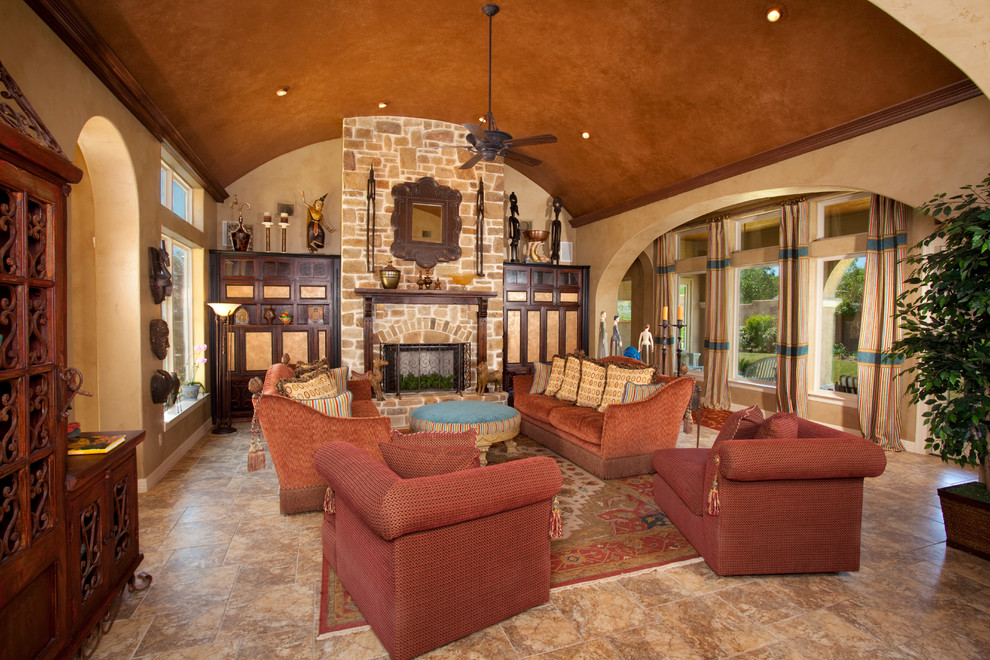 Mediterranean open concept family room in Austin with beige walls, a standard fireplace and a stone fireplace surround.