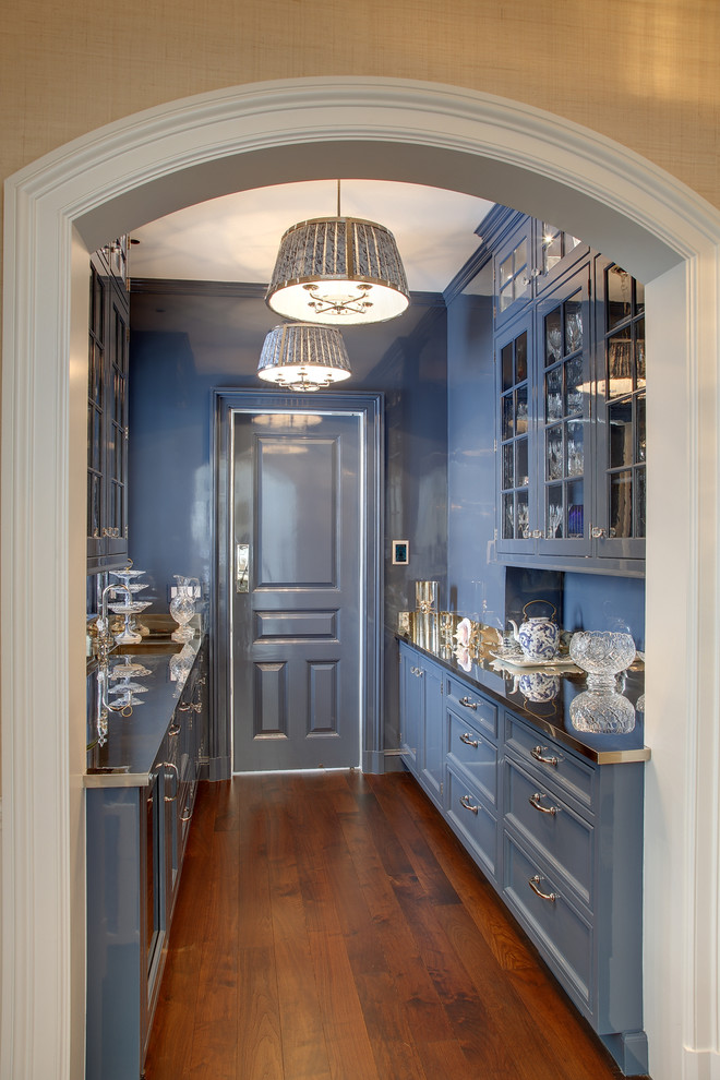 Design ideas for a large traditional galley eat-in kitchen in Other with blue cabinets, stainless steel appliances, medium hardwood floors, shaker cabinets, marble benchtops, white splashback, stone slab splashback, with island and brown floor.