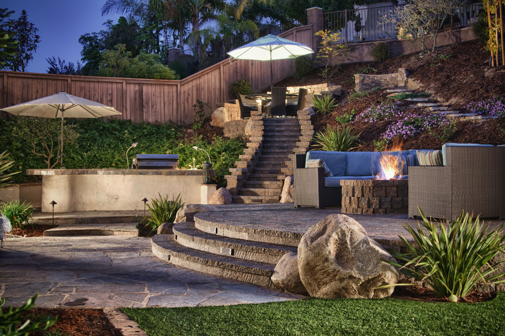 Design ideas for a large transitional backyard xeriscape in San Diego with concrete pavers.