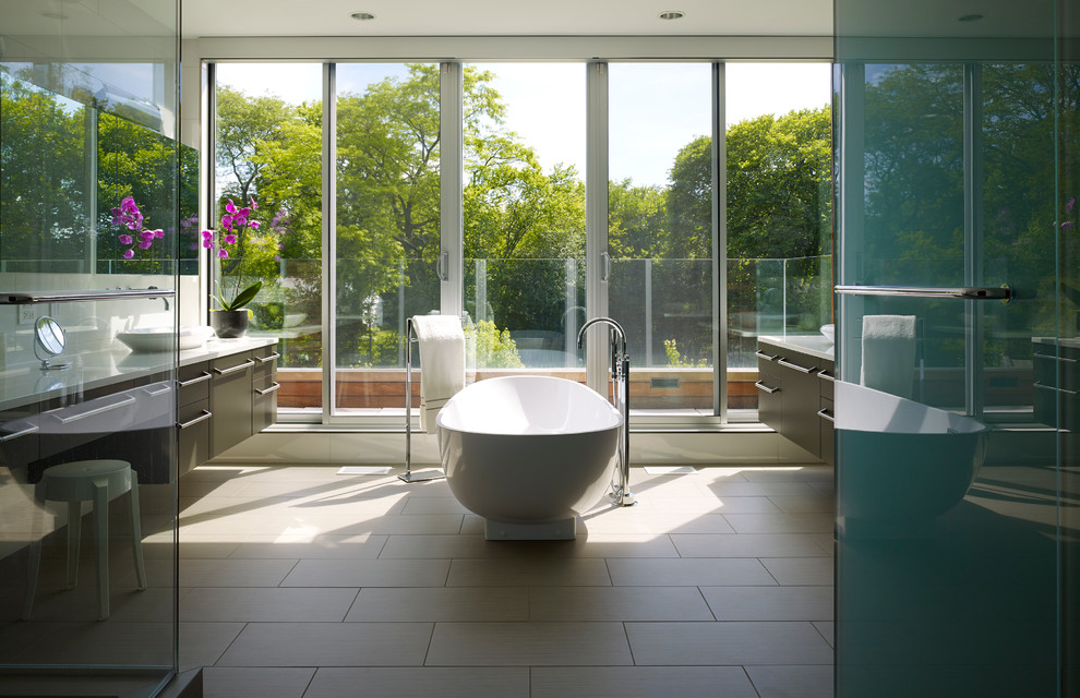 Inspiration for a large contemporary master porcelain tile and beige floor freestanding bathtub remodel in Chicago with flat-panel cabinets, dark wood cabinets, gray walls, a vessel sink and quartz countertops