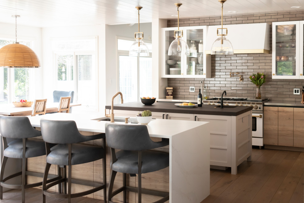 Open concept kitchen - mid-sized rustic l-shaped light wood floor, beige floor and wood ceiling open concept kitchen idea in Chicago with an undermount sink, glass-front cabinets, white cabinets, stainless steel countertops, brown backsplash, ceramic backsplash, colored appliances and two islands