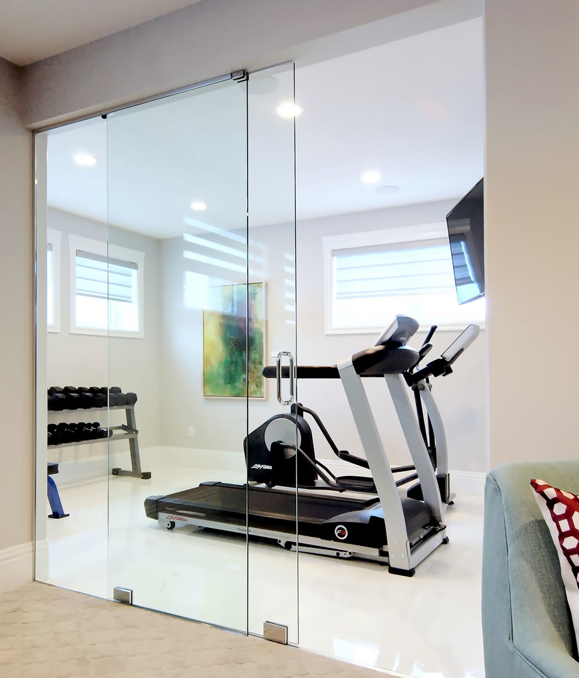 This is an example of a mid-sized transitional multipurpose gym in Edmonton with grey walls and concrete floors.