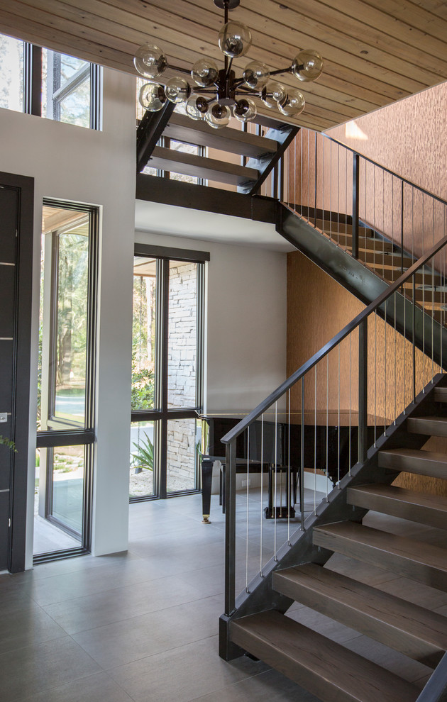 Inspiration for a large contemporary wooden floating metal railing staircase remodel in Jacksonville