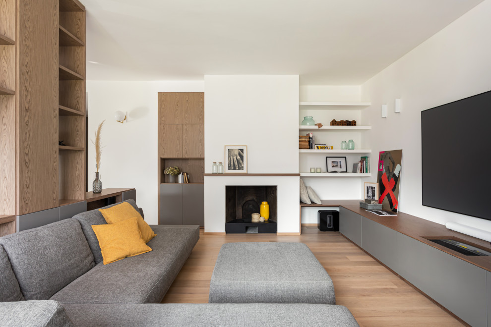 Photo of a large contemporary open concept family room in Milan with a music area, white walls, painted wood floors, a standard fireplace, a metal fireplace surround, a built-in media wall and beige floor.