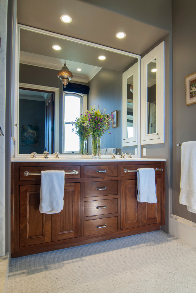 This is an example of a mid-sized traditional master bathroom in San Francisco with an undermount sink, flat-panel cabinets, medium wood cabinets, marble benchtops, an alcove shower, white tile, ceramic tile, grey walls and marble floors.