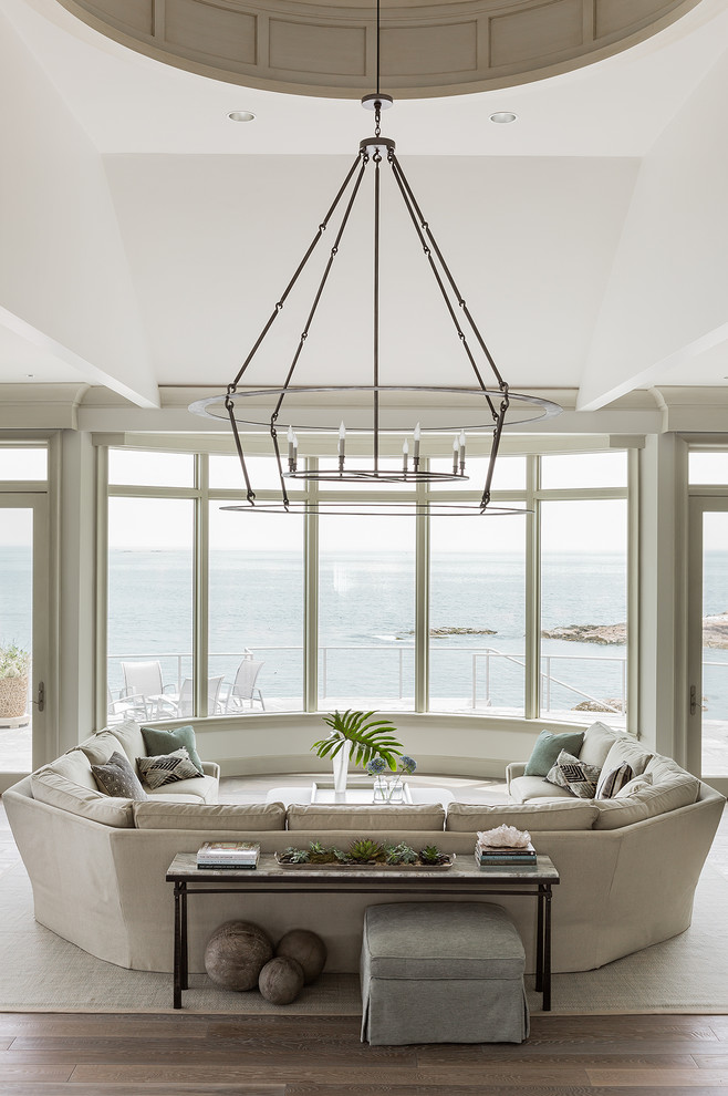 This is an example of an expansive transitional open concept living room in Boston with beige walls.