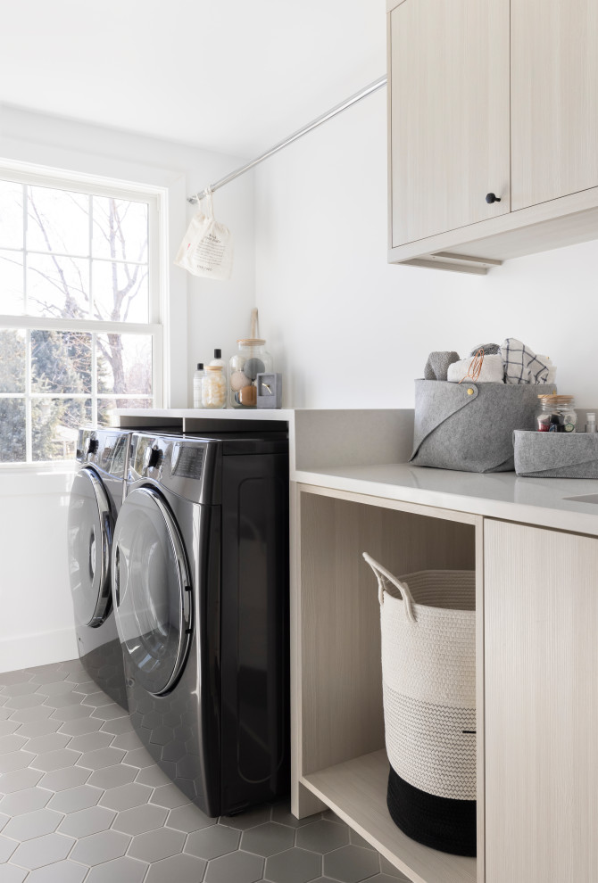 Mid-sized contemporary single-wall dedicated laundry room in Denver with a single-bowl sink, flat-panel cabinets, light wood cabinets, quartz benchtops, a side-by-side washer and dryer and white benchtop.