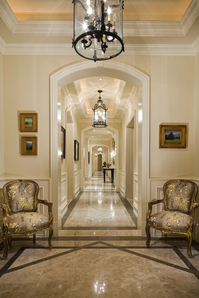 This is an example of a traditional hallway in Los Angeles with beige walls and multi-coloured floor.