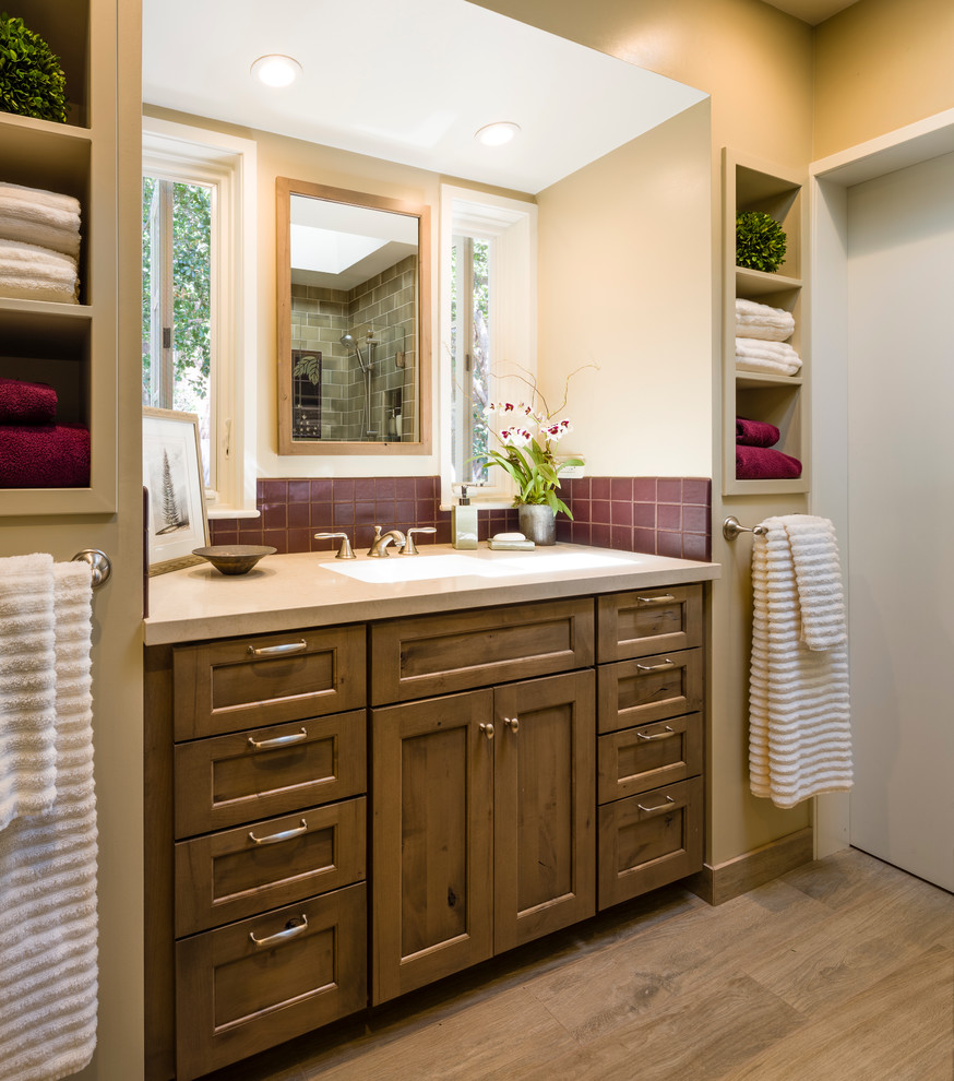 Inspiration for a small transitional master bathroom in San Francisco with an undermount sink, recessed-panel cabinets, medium wood cabinets, engineered quartz benchtops, an alcove shower, a one-piece toilet, multi-coloured tile, ceramic tile, beige walls and porcelain floors.
