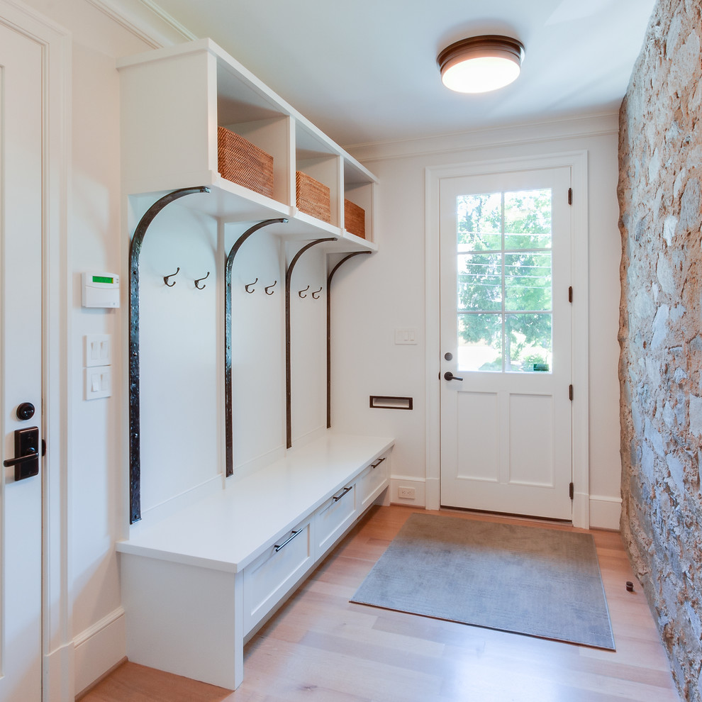 Mid-sized traditional mudroom in Other with white walls, light hardwood floors, a single front door and a white front door.