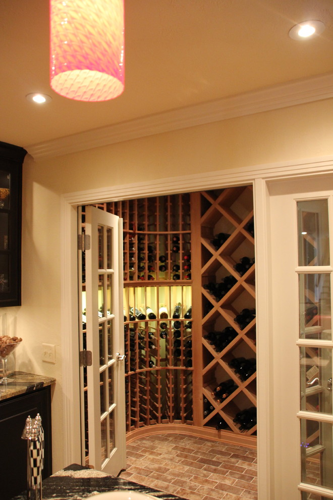 Inspiration for a mid-sized traditional wine cellar in Other with medium hardwood floors and brown floor.