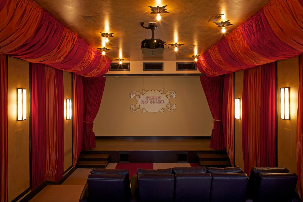 This is an example of a beach style home theatre in Grand Rapids with carpet and a projector screen.