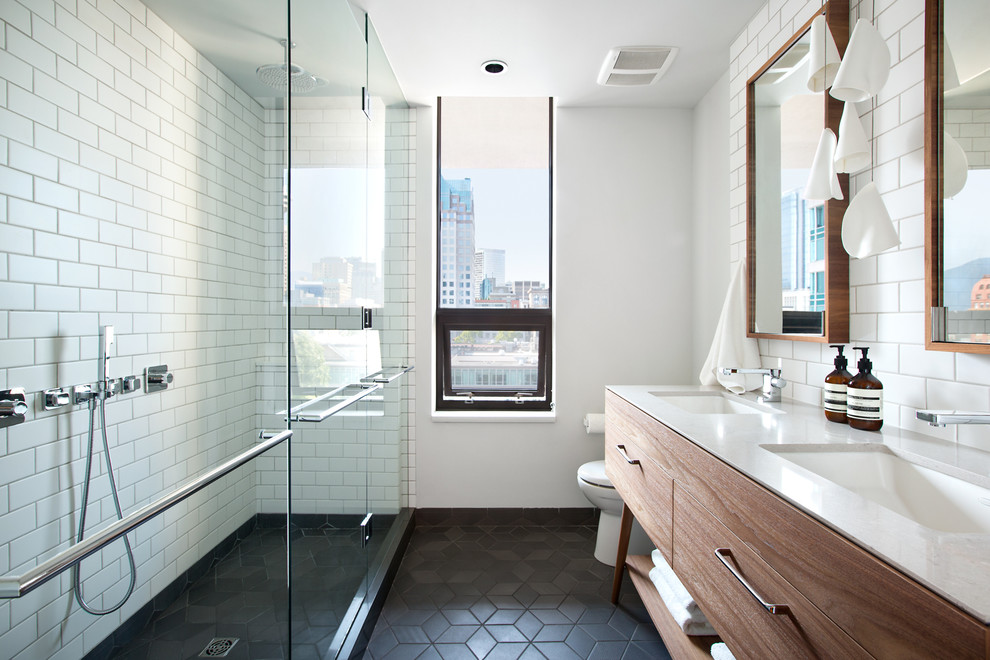Design ideas for a mid-sized modern master bathroom in Vancouver with an undermount sink, furniture-like cabinets, medium wood cabinets, engineered quartz benchtops, a one-piece toilet, black and white tile, ceramic tile, white walls, ceramic floors and an alcove shower.