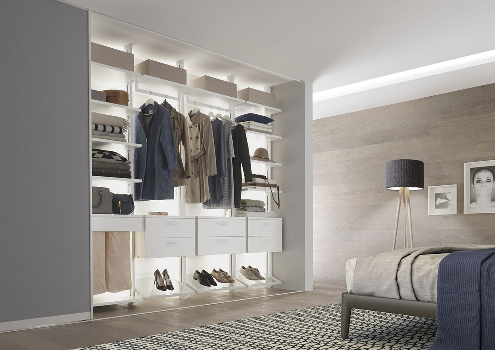 Design ideas for a mid-sized scandinavian women's dressing room in Stuttgart with open cabinets, white cabinets, light hardwood floors and beige floor.