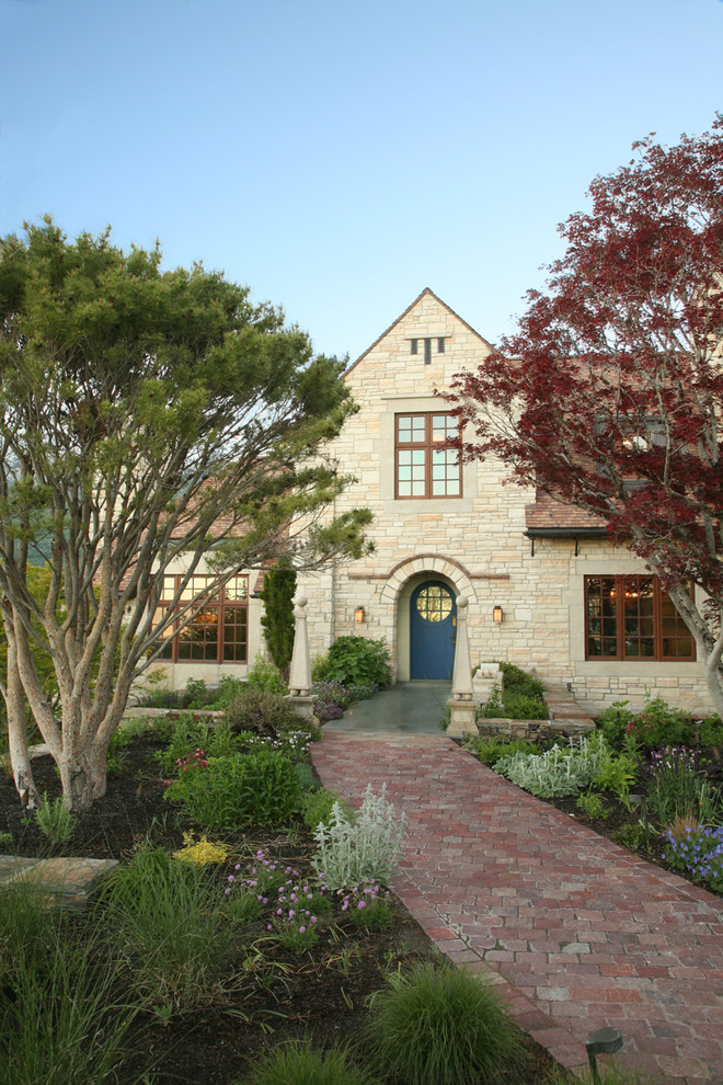 Inspiration for a traditional two-storey beige exterior in Salt Lake City with stone veneer.