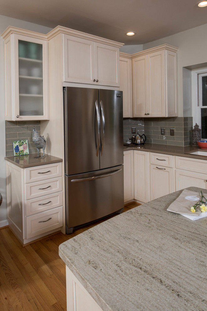 Transitional l-shaped light wood floor eat-in kitchen photo in Raleigh with an undermount sink, shaker cabinets, blue backsplash, stainless steel appliances and an island