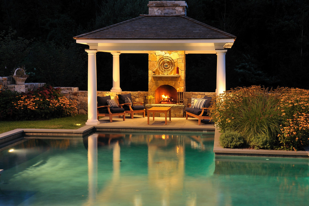 This is an example of a traditional custom-shaped pool in New York with a pool house.