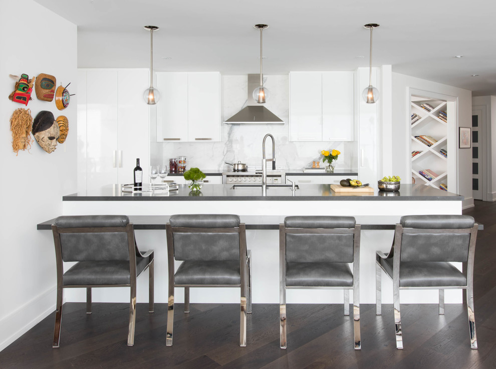 Design ideas for a mid-sized contemporary galley kitchen in Toronto with an undermount sink, flat-panel cabinets, white cabinets, quartz benchtops, white splashback, stone slab splashback, stainless steel appliances, dark hardwood floors and a peninsula.
