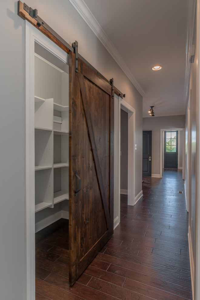 Inspiration for a mid-sized transitional dark wood floor hallway remodel with gray walls