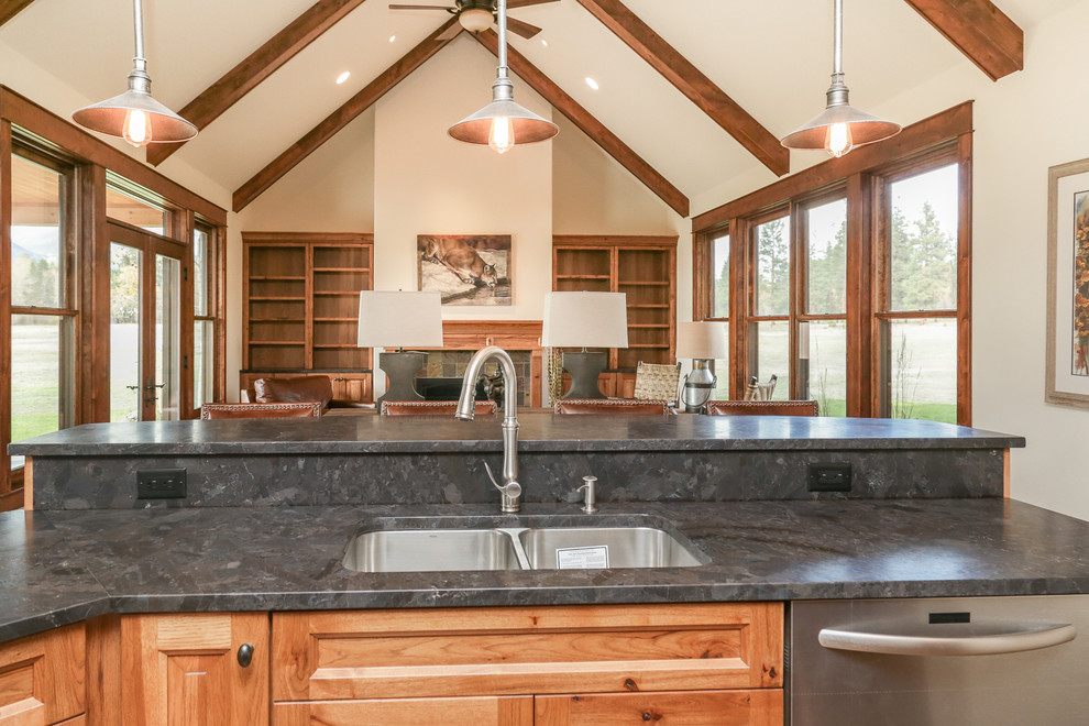 Inspiration for a mid-sized rustic l-shaped dark wood floor and brown floor open concept kitchen remodel with an undermount sink, raised-panel cabinets, medium tone wood cabinets, two islands and gray countertops