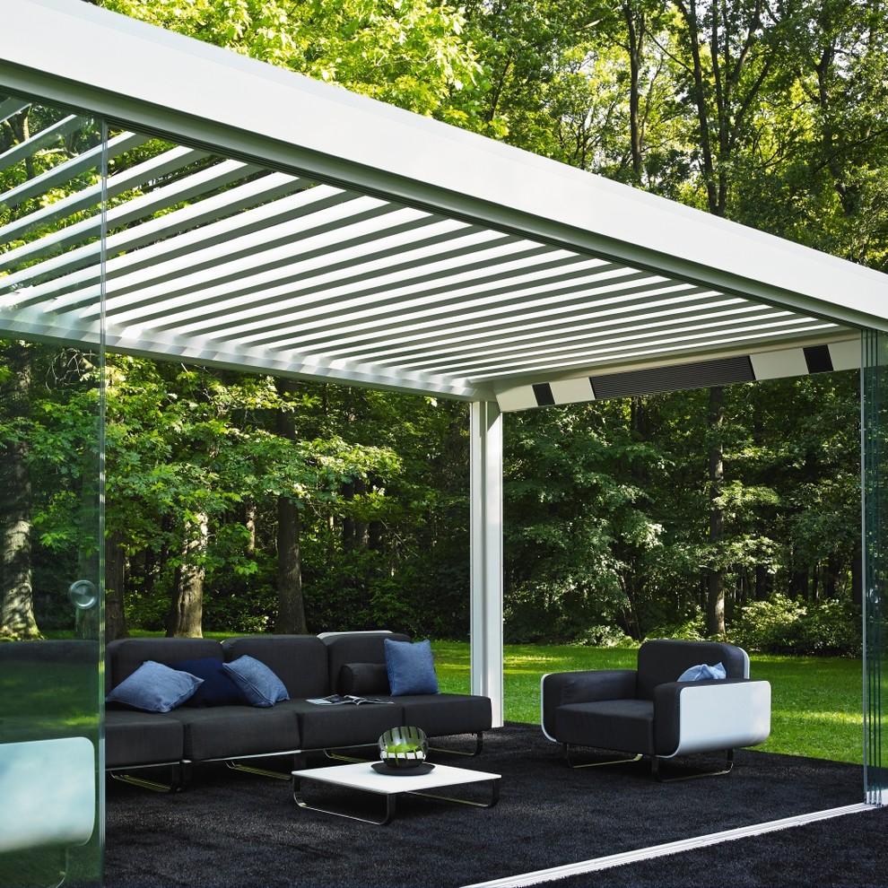 Inspiration for a mid-sized contemporary patio in New York with a pergola.