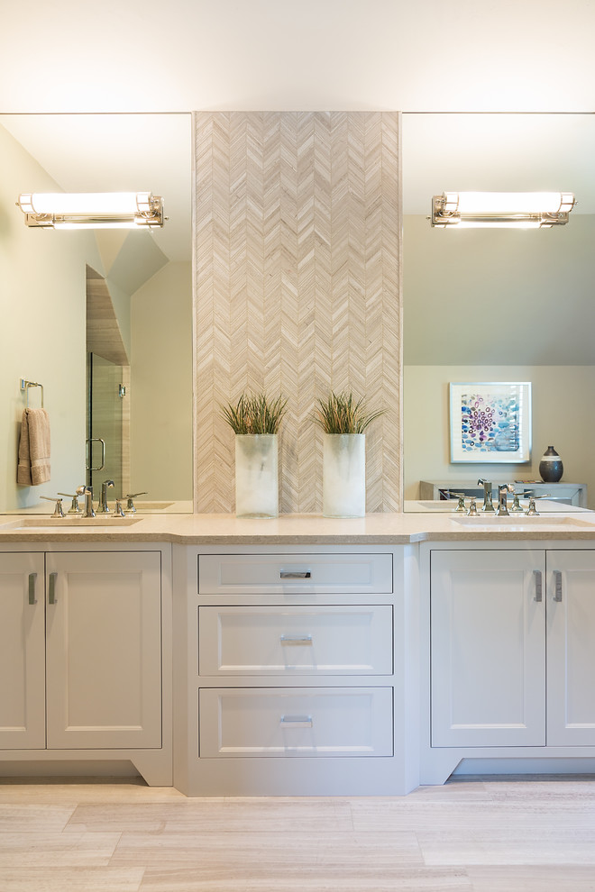 This is an example of a mid-sized transitional 3/4 bathroom in Other with recessed-panel cabinets, white cabinets, beige tile, ceramic tile, limestone benchtops, an alcove shower, beige walls, ceramic floors and an undermount sink.