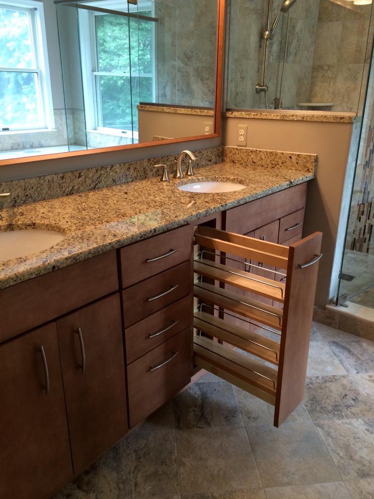 Inspiration for a large transitional master beige tile and porcelain tile porcelain tile doorless shower remodel in Baltimore with an undermount sink, granite countertops, flat-panel cabinets, medium tone wood cabinets, a two-piece toilet and beige walls