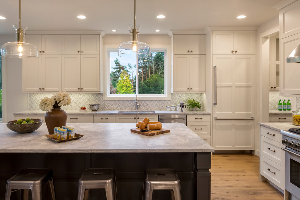 Photo of a mid-sized contemporary l-shaped open plan kitchen in Seattle with an undermount sink, shaker cabinets, white cabinets, marble benchtops, multi-coloured splashback, medium hardwood floors, with island, terra-cotta splashback and panelled appliances.