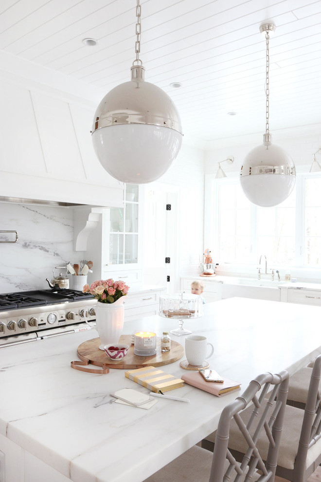 Large cottage u-shaped medium tone wood floor eat-in kitchen photo in Vancouver with white cabinets, stainless steel appliances, an island, a farmhouse sink, recessed-panel cabinets, marble countertops, white backsplash and stone slab backsplash