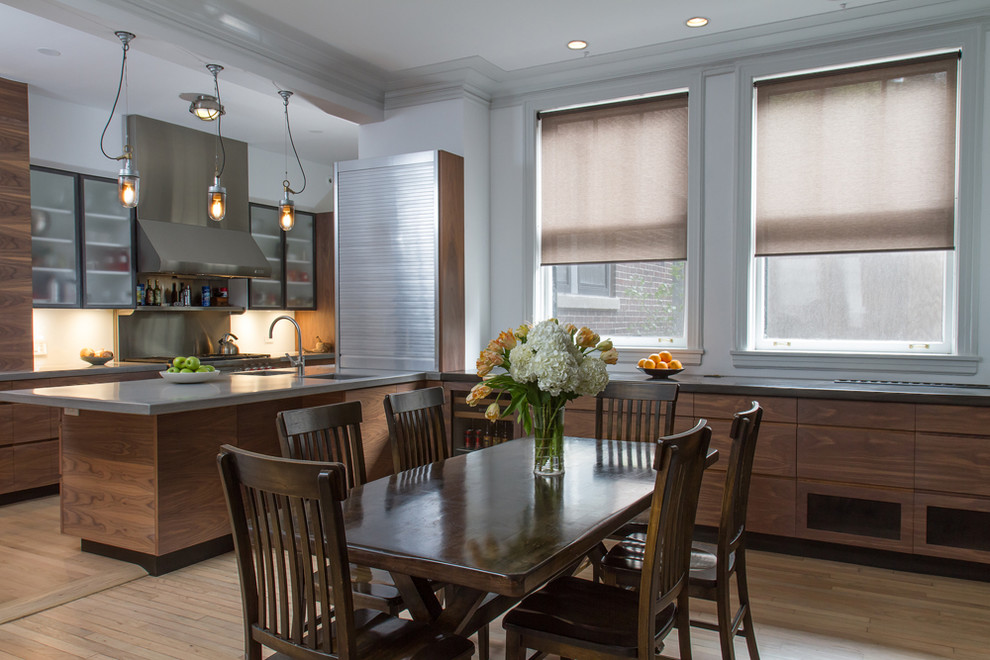 Photo of a transitional kitchen/dining combo in Chicago with white walls and medium hardwood floors.