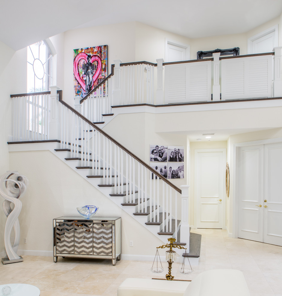 Example of a huge transitional open concept marble floor and beige floor staircase design in Miami with white walls