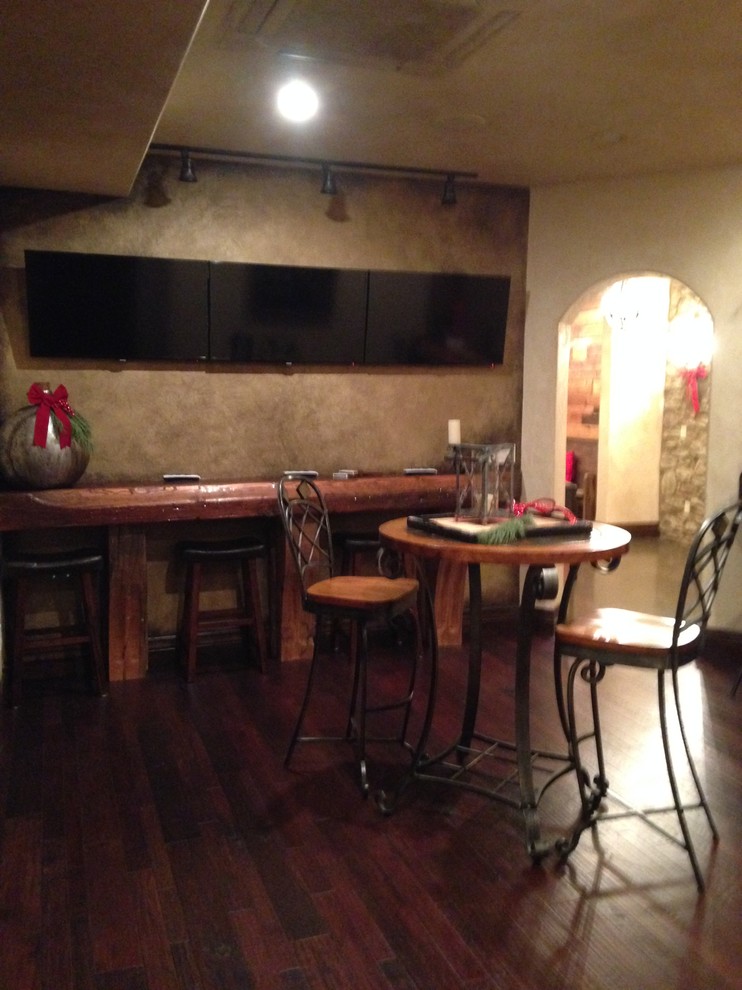 Seated home bar - mid-sized rustic single-wall seated home bar idea with dark wood cabinets