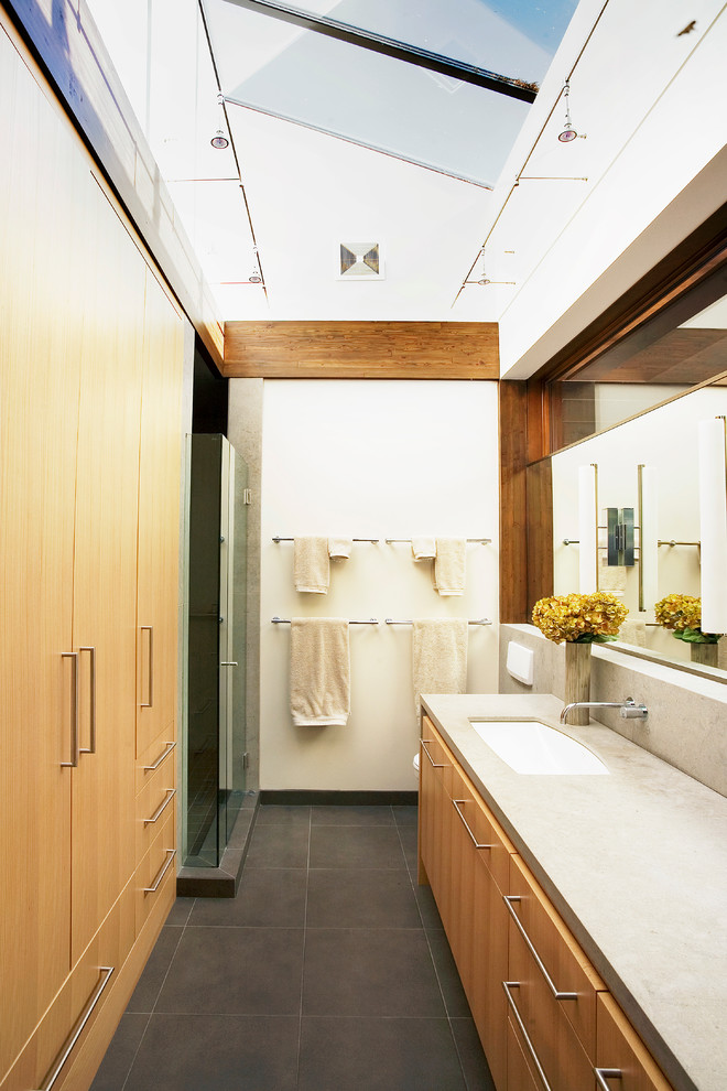 Inspiration for a mid-sized contemporary master bathroom in Vancouver with an undermount sink, flat-panel cabinets, light wood cabinets, concrete benchtops and slate floors.