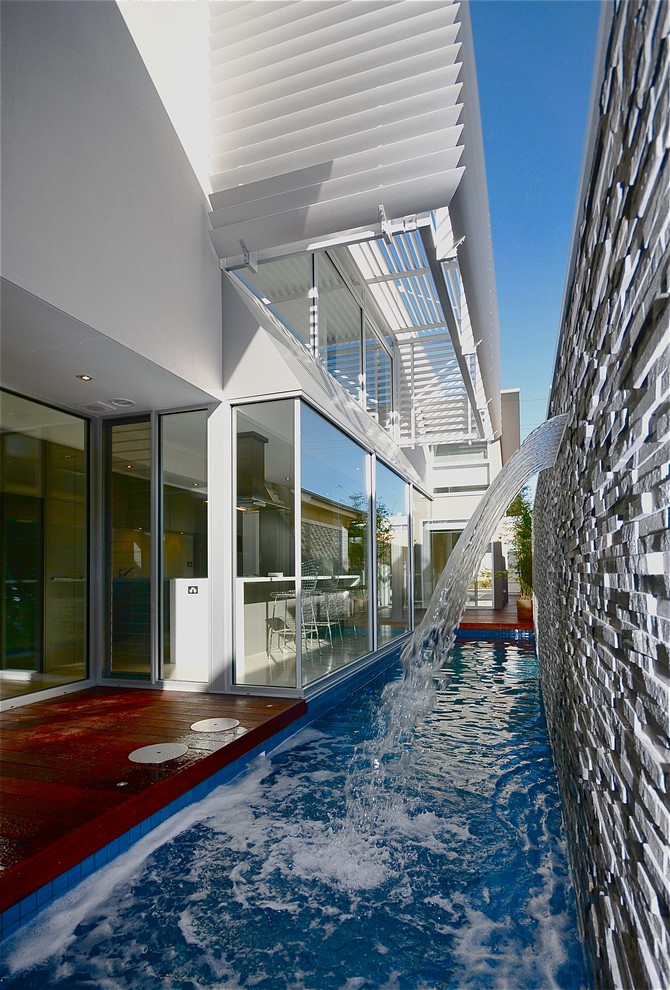 Inspiration for a small contemporary courtyard rectangular lap pool in Adelaide with decking.