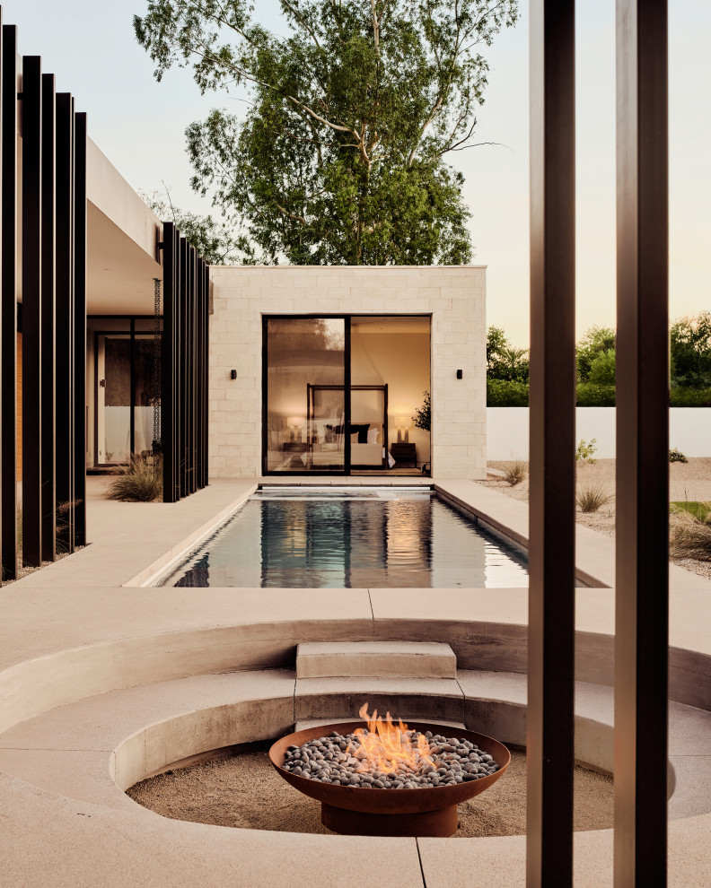 Inspiration for a modern backyard concrete and rectangular pool remodel in Phoenix