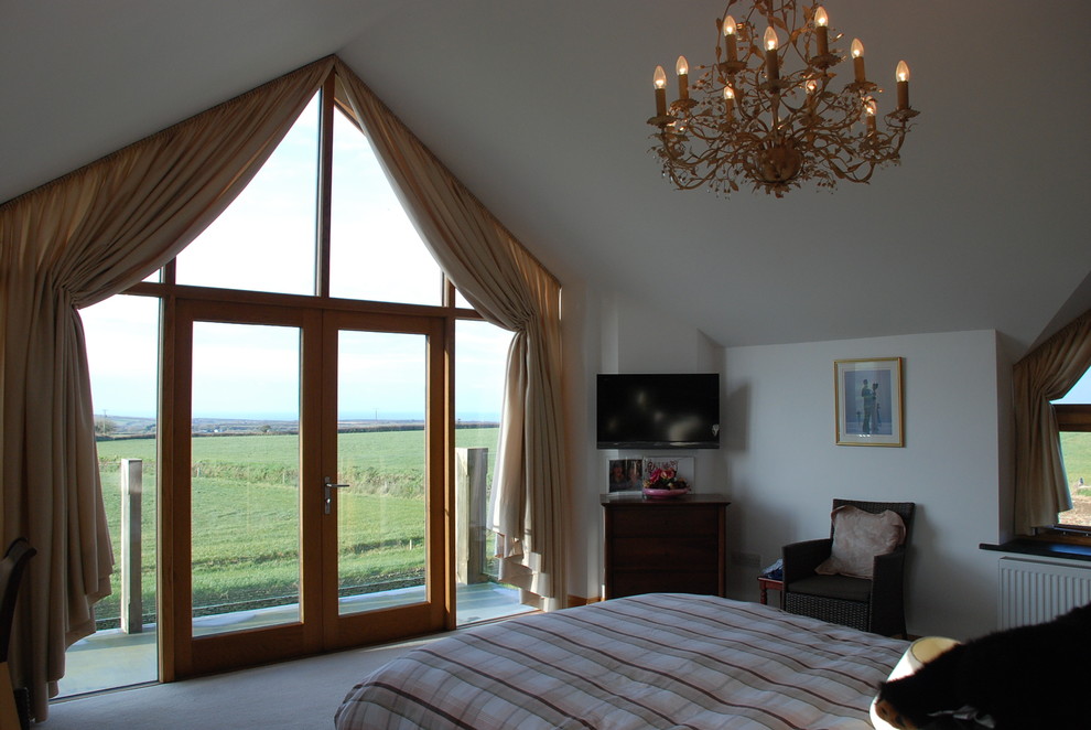 Inspiration for a large country master bedroom in Cornwall with white walls, carpet and vaulted.