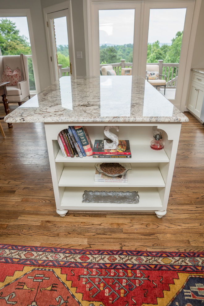 Eat-in kitchen - huge transitional l-shaped medium tone wood floor eat-in kitchen idea in Birmingham with an undermount sink, recessed-panel cabinets, white cabinets, granite countertops, multicolored backsplash, glass tile backsplash, stainless steel appliances and an island