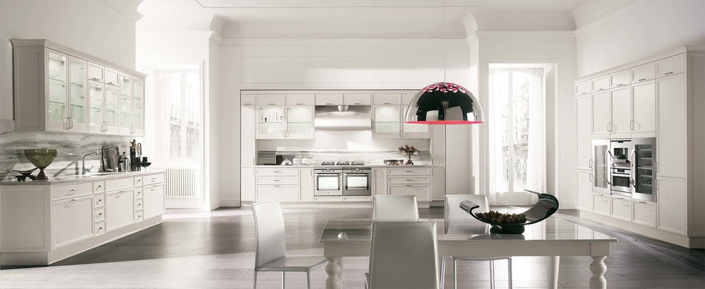 Inspiration for a transitional u-shaped eat-in kitchen remodel with flat-panel cabinets